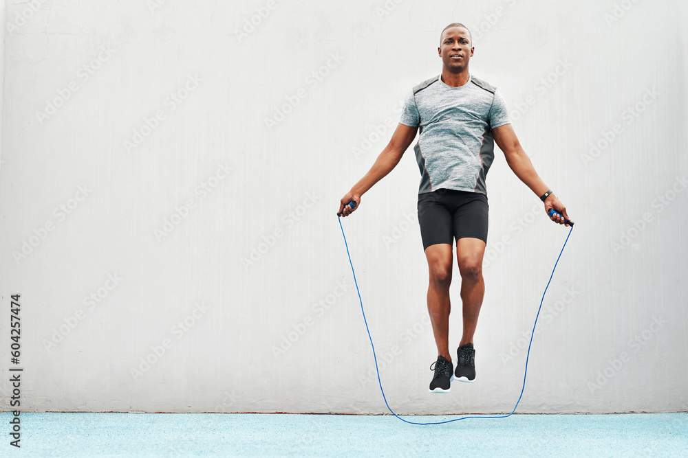 Jump rope and training with black man skipping in stadium for sports workout practice and cardio