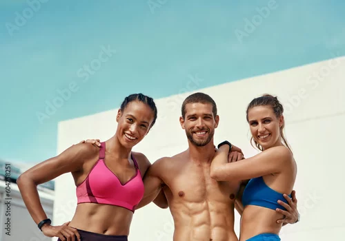 Obraz Sports, muscle and portrait of fitness friends with blue sky at outdoor gym with smile and wellness with mockup. Workout, exercise and personal trainer man with women, happiness and healthy mindset.