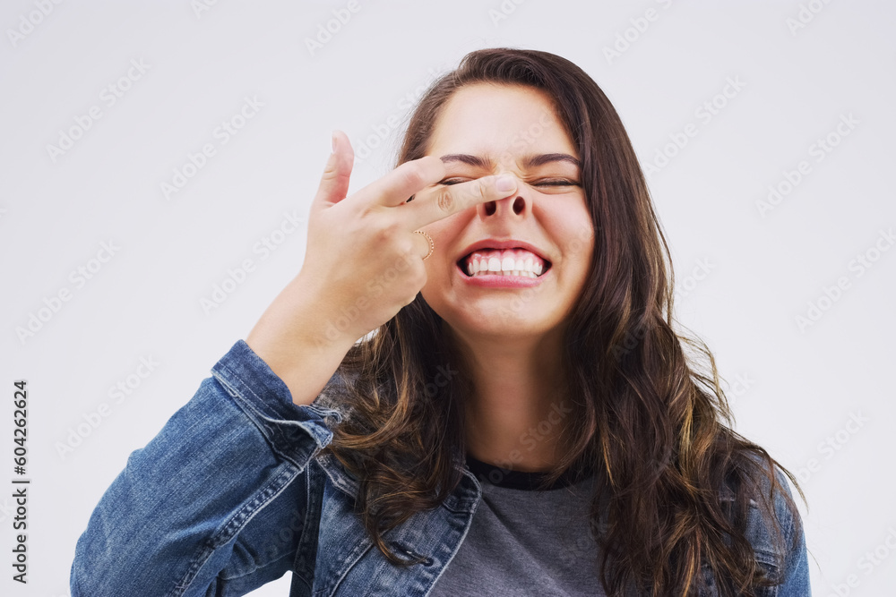 Smile, funny face and nose with a crazy woman in studio on a white background for carefree humor. Comic, comedy and showing nostrils with a weird young female person feeling playful while joking - obrazy, fototapety, plakaty 