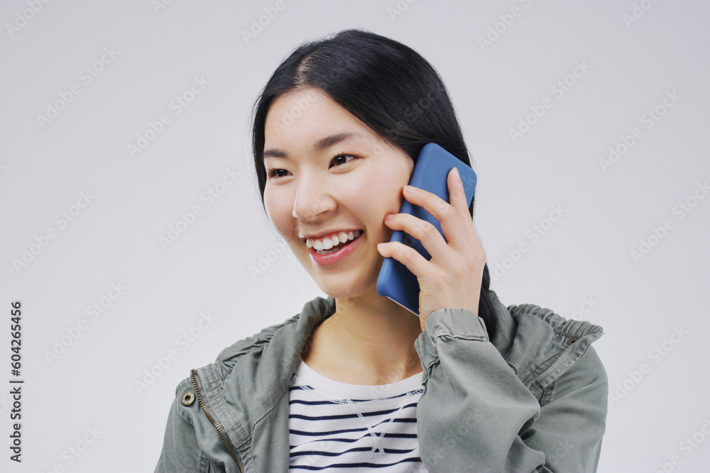 Smile, phone call and Asian woman talking in studio isolated on a white background with mockup. Funny, cellphone and female person speaking, discussion or communication, conversation and networking. Smile, phone call and Asian woman talking in studio isolated on a white background with mockup. Funny, cellphone and female person speaking, discussion or communication, conversation and networking.