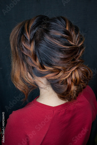 Photo of a stylish female hairstyle, on the back of the girl's head. Image for your creative decoration or design.