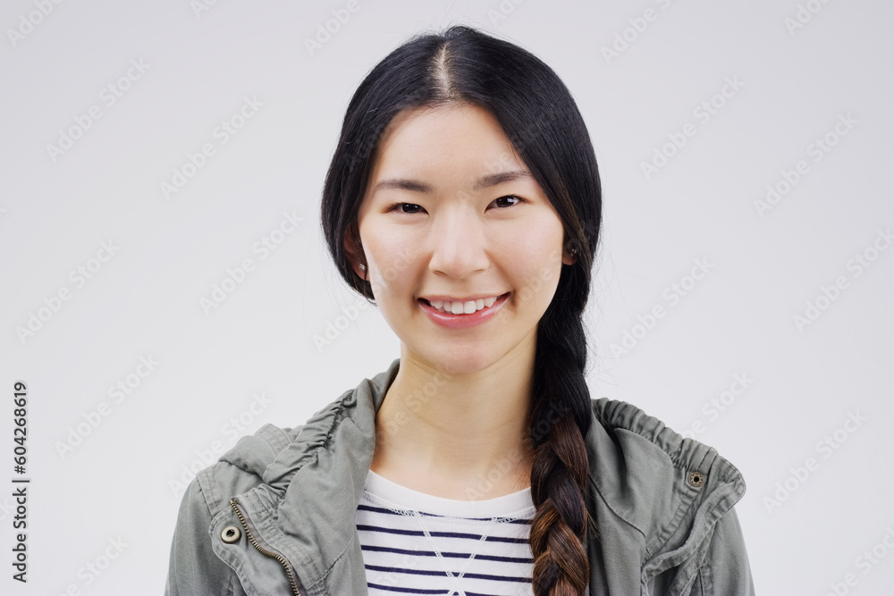 Portrait, happy or smile with an asian woman in studio on white background for japanese fashion. Face, contemporary or style with an attractive young female person looking confident in trendy clothes Portrait, happy or smile with an asian woman in studio on white background for japanese fashion. Face, contemporary or style with an attractive young female person looking confident in trendy clothes