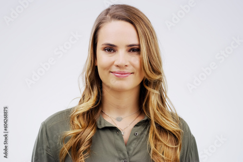 Portrait, happy and smile with a woman in studio on a white background for contemporary style. Face, confident or natural with an attractive young german female model posing alone in trendy fashion