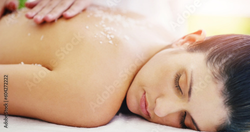 Spa, relax and woman doing back scrub skincare as self love, cosmetic and luxury stress relief with salt for the body. Massage, beauty and person in a dermatology salon to exfoliate for wellness