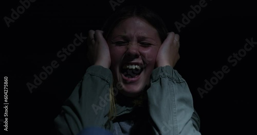 Child, scream and fear with stress in the dark is at risk of human trafficking or abuse. Kid, anxiety and screams with terror and mental health at night with violence and trouble for scared victim. photo