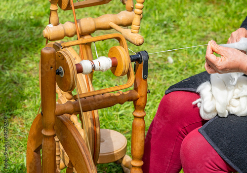 wooden spinning wheel with yarn