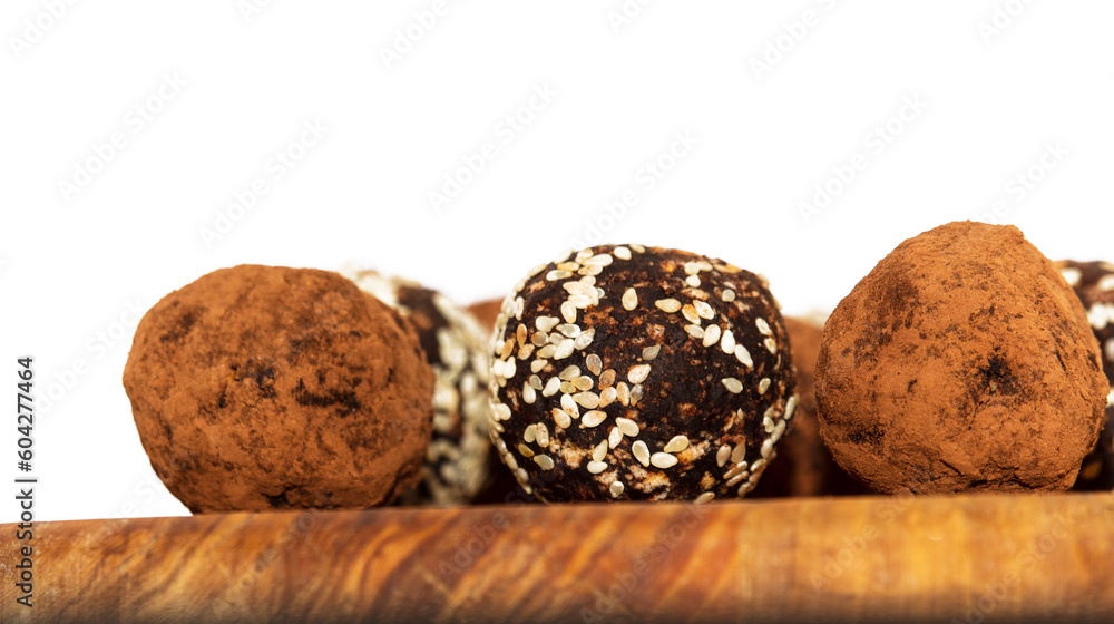 Energy balls in white bowl. Healthy raw dessert, vegetarian truffles, sugar free candies made of dates, hazelnuts, cocoa powder. Energy balls in white bowl. Healthy raw dessert, vegetarian truffles, sugar free candies made of dates, hazelnuts, cocoa powder.