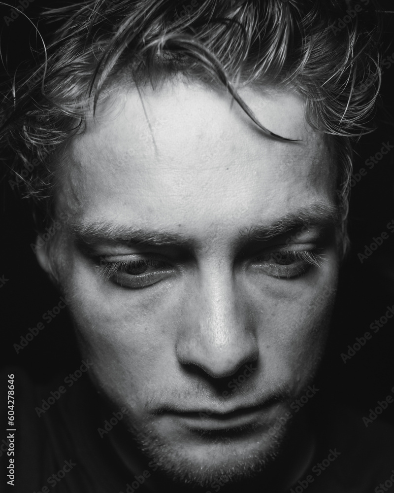 A man in a dark room deep with emotion A man in a dark room deep with emotion