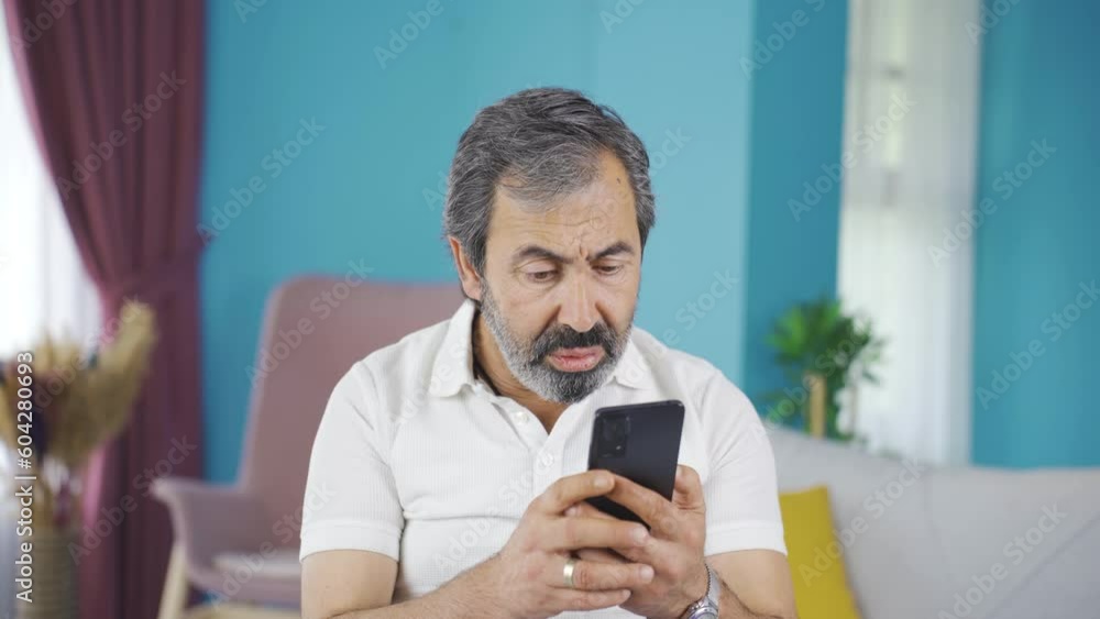 Middle-aged man looking at phone is disappointed. Middle-aged man looking at phone is disappointed.