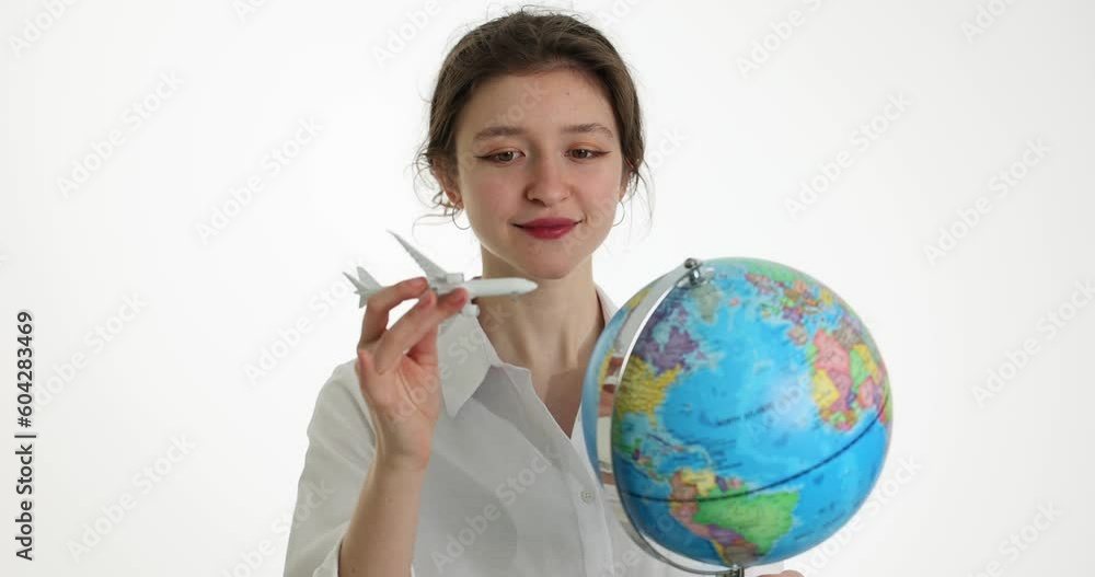 Travel world by plane. Pretty girl holding an airplane and world map globe concept Travel world by plane. Pretty girl holding an airplane and world map globe concept