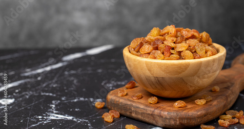 Raisins. Sun-dried grapes in wooden bowl. superfood. Vegetarian food concept. healthy snacks. Copy space. Empty space for text photo