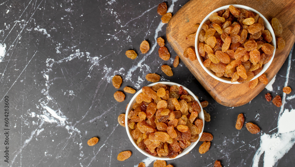 Fototapeta premium Raisins. Sun-dried grapes in ceramic bowl. superfood. Vegetarian food concept. healthy snacks. Top view. Copy space. Empty space for text
