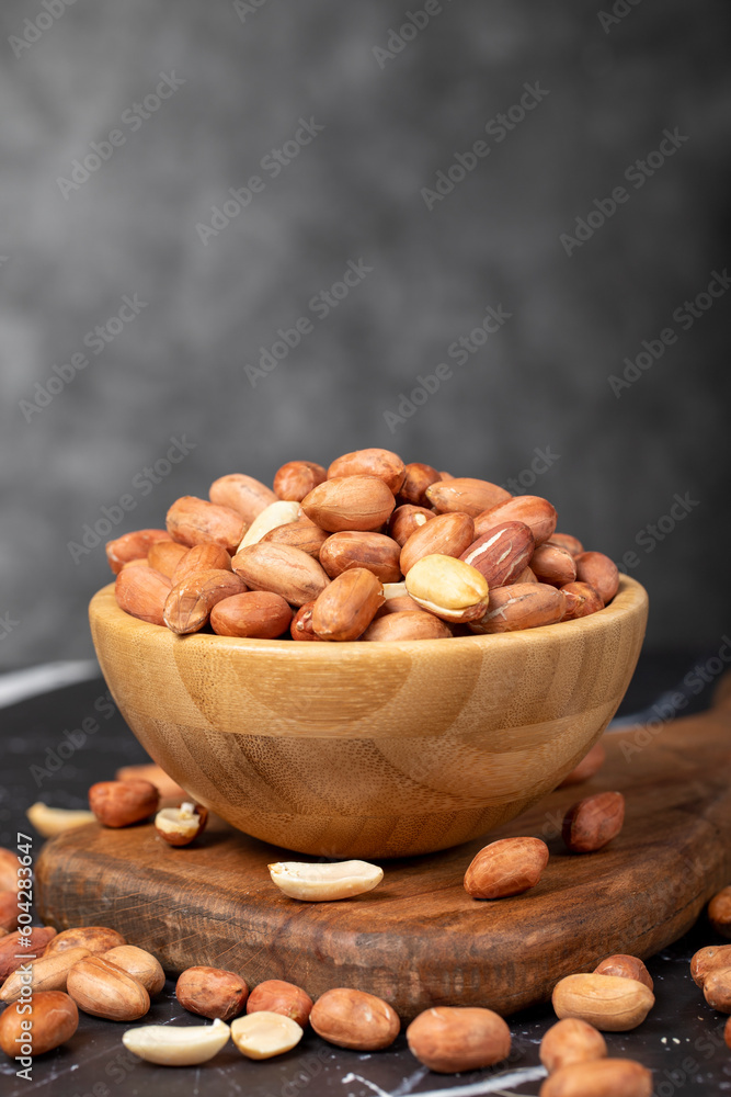 Peanut. Peanuts peeled in a wooden bowl. superfood. Vegetarian food concept. healthy snacks. close up Peanut. Peanuts peeled in a wooden bowl. superfood. Vegetarian food concept. healthy snacks. close up