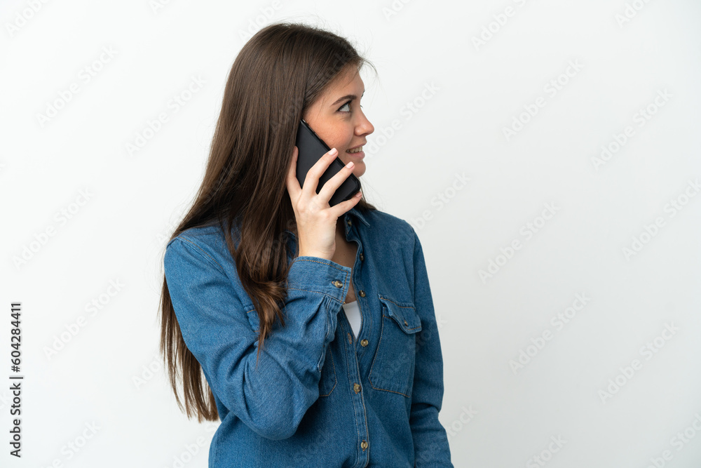 Young caucasian woman isolated on white background keeping a conversation with the mobile phone with someone Young caucasian woman isolated on white background keeping a conversation with the mobile phone with someone