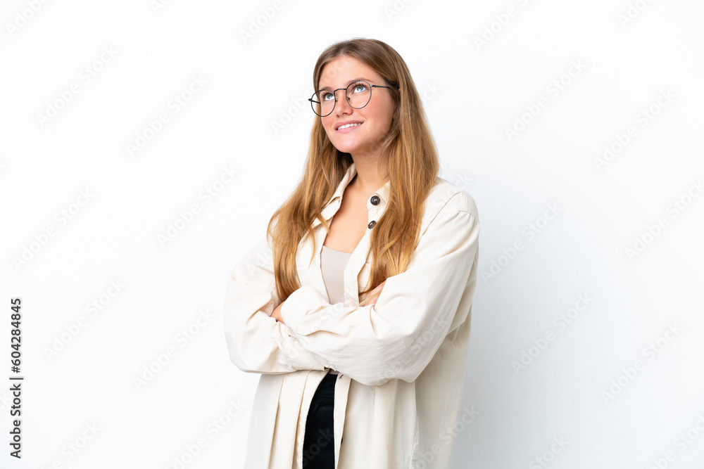 Young blonde woman isolated on white background looking up while smiling Young blonde woman isolated on white background looking up while smiling