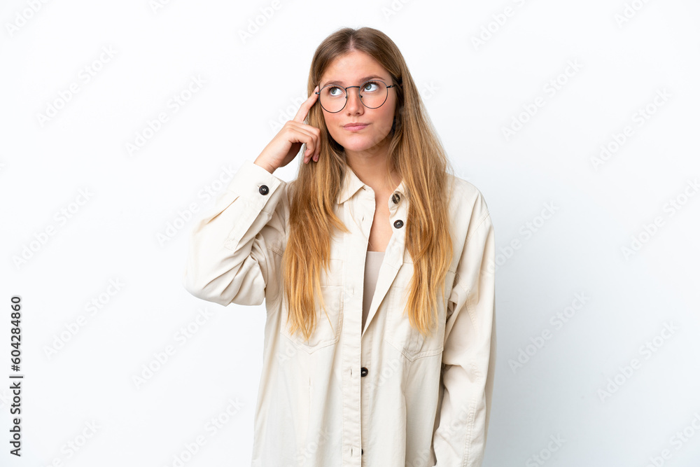 Young blonde woman isolated on white background making the gesture of madness putting finger on the head Young blonde woman isolated on white background making the gesture of madness putting finger on the head
