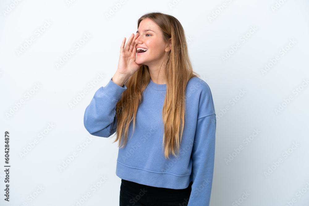 Young blonde woman isolated on white background shouting with mouth wide open to the side Young blonde woman isolated on white background shouting with mouth wide open to the side