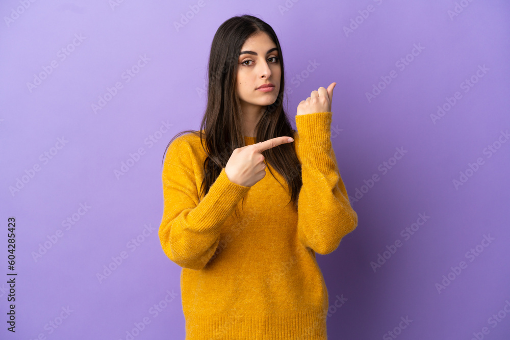 Young caucasian woman isolated on purple background making the gesture of being late Young caucasian woman isolated on purple background making the gesture of being late
