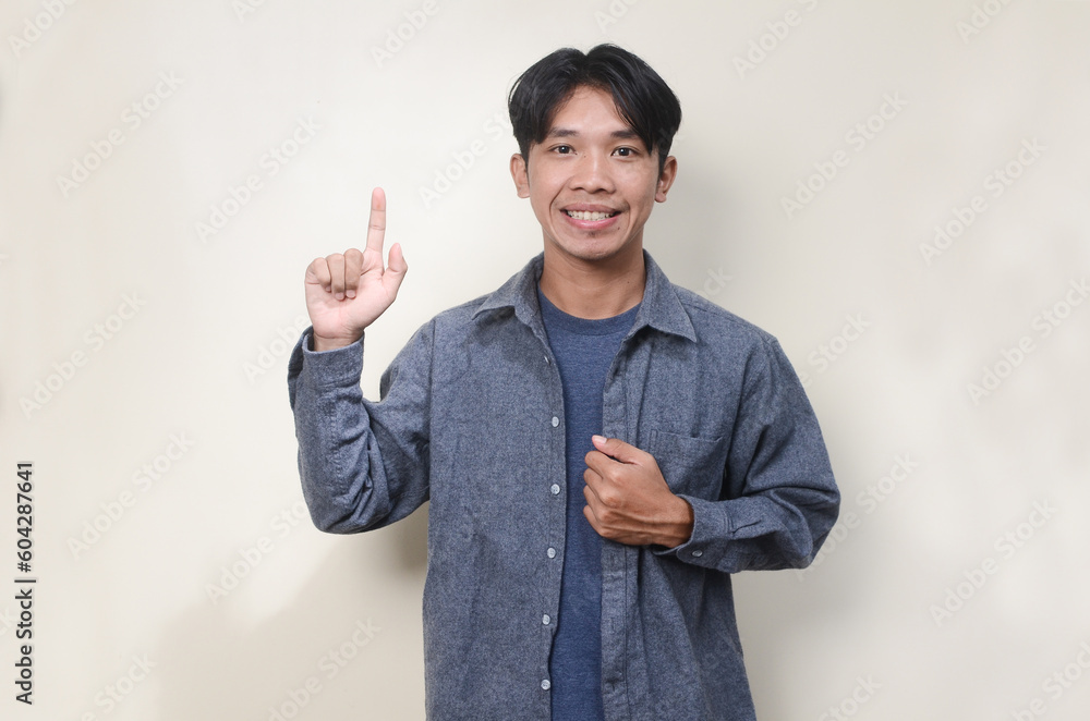 Young Man Pointing Up, Smiling Expression