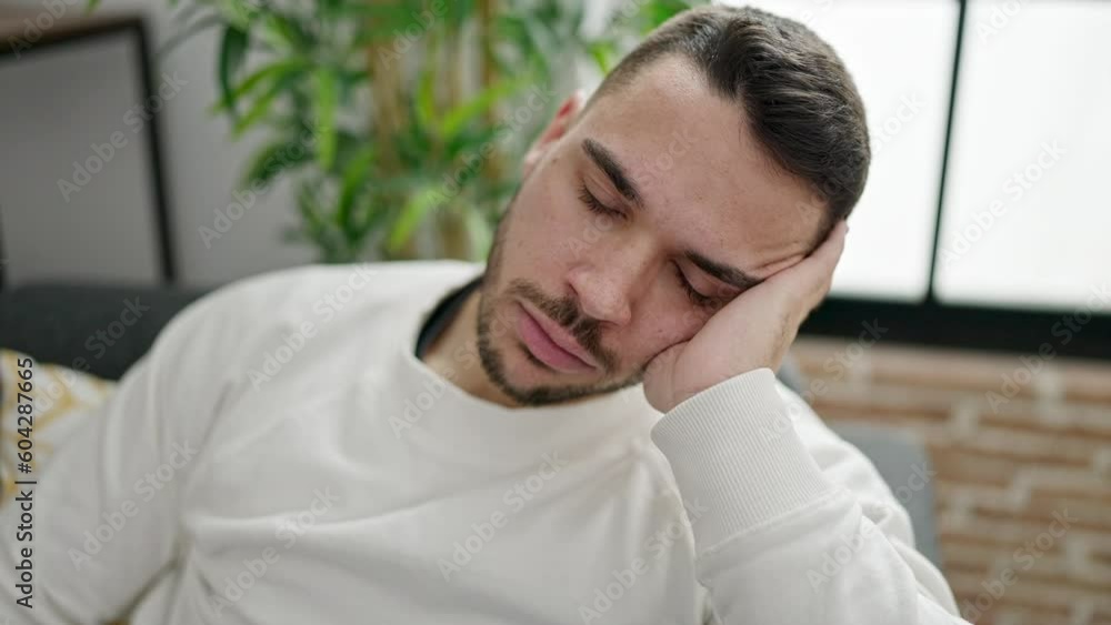 Young hispanic man sitting on sofa sleeping at home Young hispanic man sitting on sofa sleeping at home