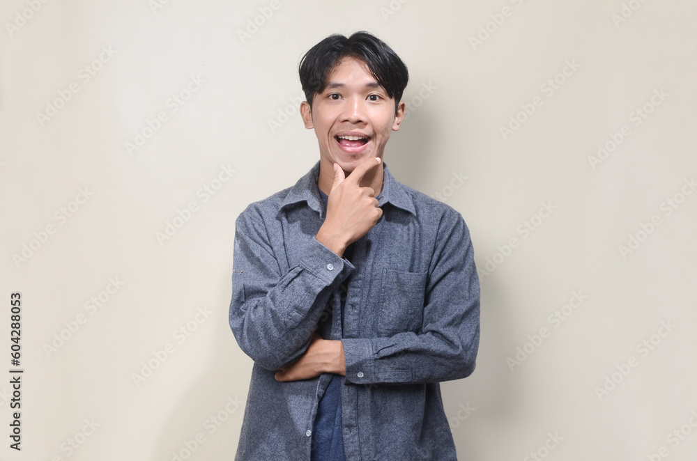 Young business man wearing gray suit against background Young business man wearing gray suit against background