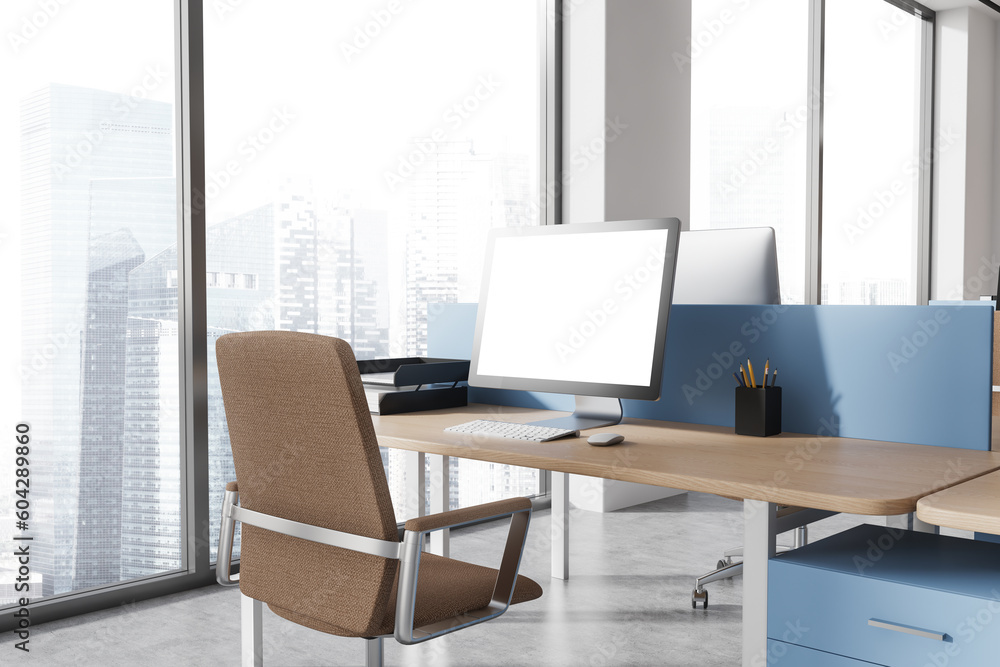 Mock up computer screen on blue and wooden office table