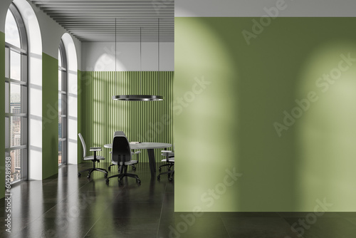 Green meeting room interior with round table and mock up wall