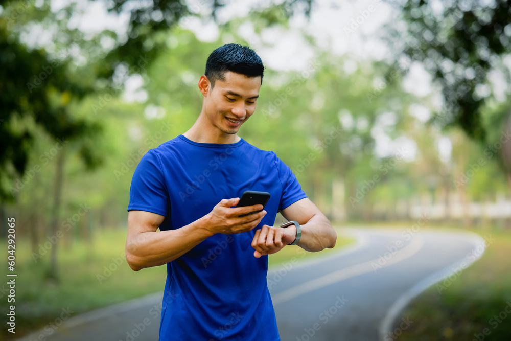 Satisfied male athlete checking training program on smartphone application. Technology health, wellness concept Satisfied male athlete checking training program on smartphone application. Technology health, wellness concept