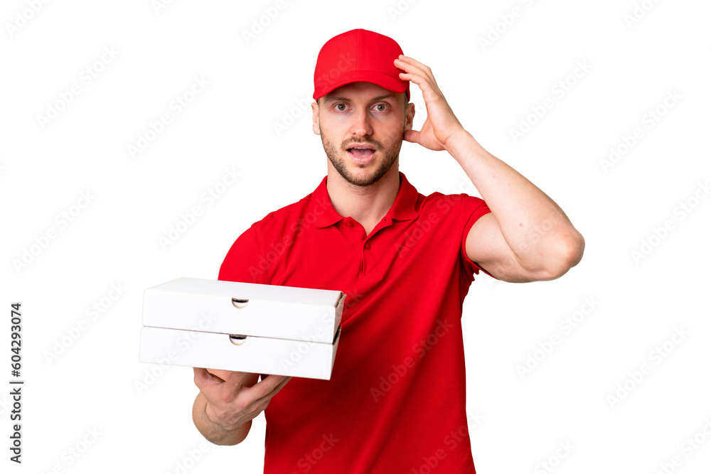 Pizza delivery man with work uniform picking up pizza boxes over isolated chroma key background with surprise expression Pizza delivery man with work uniform picking up pizza boxes over isolated chroma key background with surprise expression