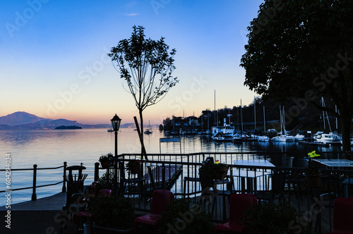 Charming sunset over the marina on Lake Maggiore. Piedmont, Italy