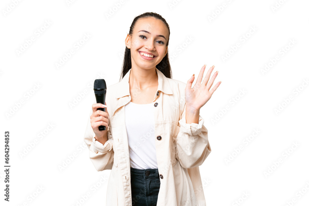 Young singer woman picking up a microphone over isolated chroma key background saluting with hand with happy expression Young singer woman picking up a microphone over isolated chroma key background saluting with hand with happy expression