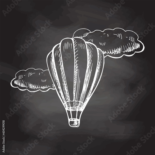 Hand drawn sketch of hot air balloon with clouds. Vintage vector illustration isolated on chalkboard  background. Doodle drawing.