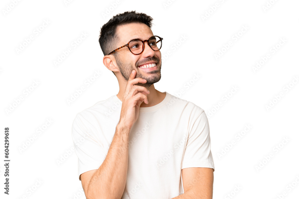 Young handsome caucasian man over isolated chroma key background thinking an idea while looking up Young handsome caucasian man over isolated chroma key background thinking an idea while looking up