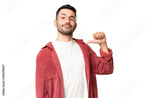 Photos Young handsome caucasian man over isolated chroma key background proud and self-