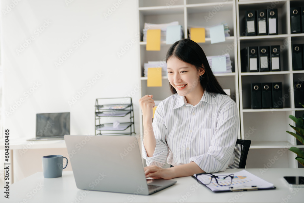 Asian business woman are delighted and happy with the work they do on their tablet, laptop and taking notes at office... Asian business woman are delighted and happy with the work they do on their tablet, laptop and taking notes at office...