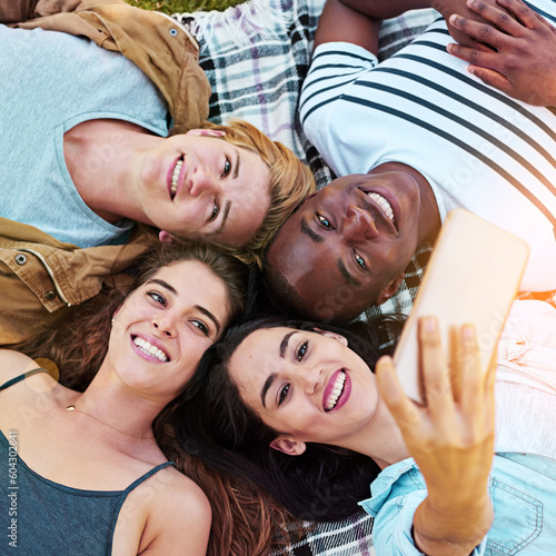 Friends  top view and outdoor for circle selfie  happiness and diversity for social media post  app or blog. Men  woman and youth for photography  profile picture and bonding while lying on ground