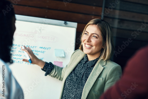 Presentation whiteboard, audience and happy woman planning, coaching and present strategy, ideas or office plan. Sales workshop, project management and team leader, boss or person speaking to group photo