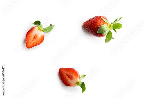 Fototapeta Naklejka Na Ścianę i Meble -  Strawberries on a white background. One whole berry and two halves of juicy fruit. Composition in the style of flat lay.
