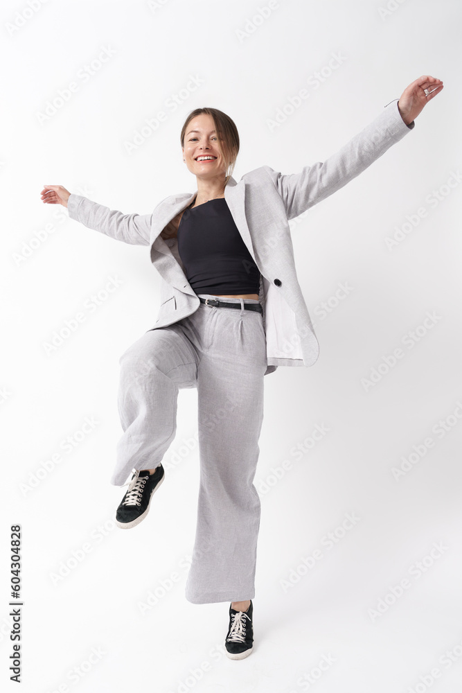 Young caucasian woman, professional entrepreneur standing in office clothing, smiling on white background. Full length portrait Young caucasian woman, professional entrepreneur standing in office clothing, smiling on white background. Full length portrait