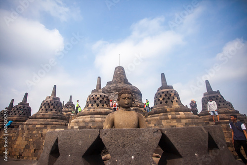 Buddha statues and stupas in the Borobudur Temple complex. Borobudur Temple is the largest Buddhist temple in the world located in Magelang, Jogjakarta, Indonesia.