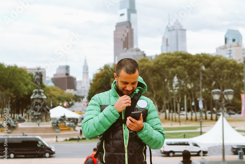 middle aged man using mobile phone outdoors photo