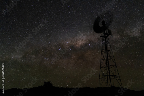 Night sky milky way galaxy with windmill silhouetted