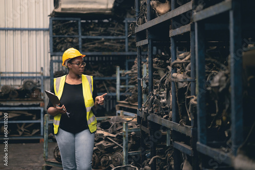 Black African women engineer worker working check stock in factory industry machine part warehouse.