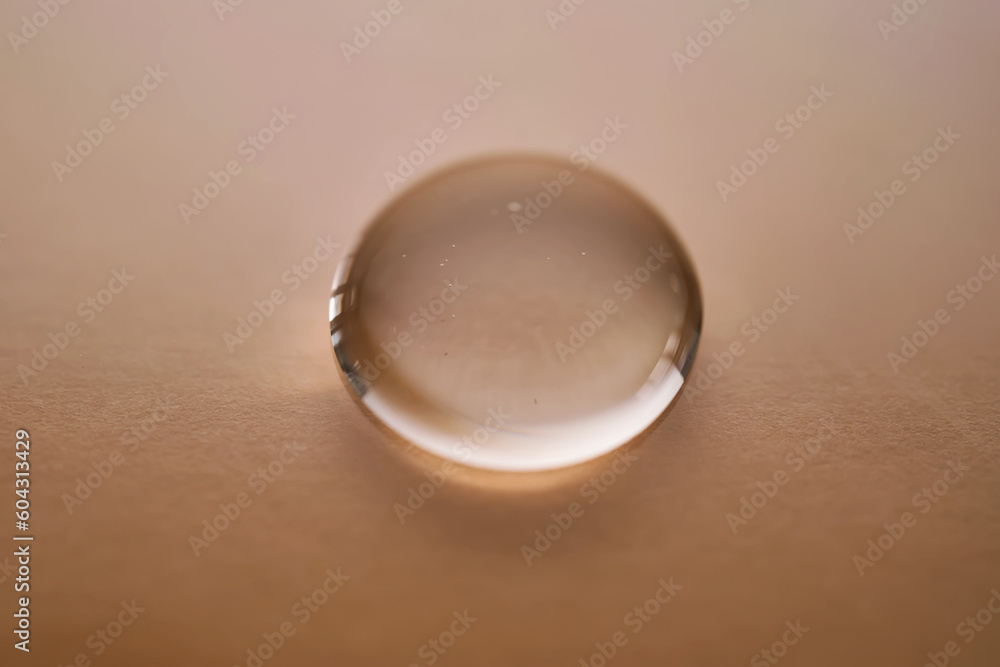 A juicy drop of gel on a beige background. A juicy drop of gel on a beige background.