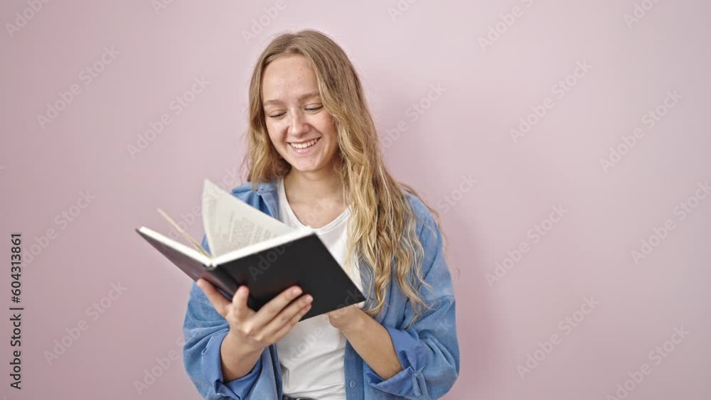 Young blonde woman smiling confident reading book over isolated pink background Young blonde woman smiling confident reading book over isolated pink background