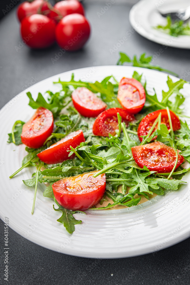 plate of salad tomato, arugula, grated cheese, olive oil healthy meal food snack on the table copy space food background rustic top view keto or paleo diet veggie vegan or vegetarian food no meal 