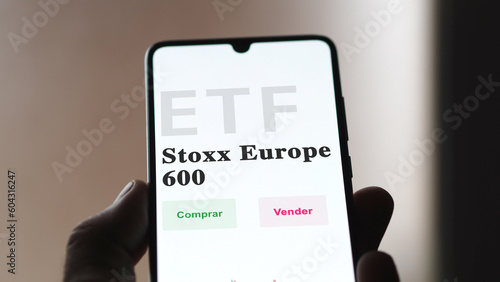 March 2023, An investor analyzing an etf fund. ETF text in Spanish : STOXX Europe 600, buy, sell. photo