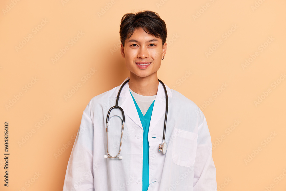 On a blue background, a girl in a doctor's outfit, with stethoscope, poses  proudly knowing the profession's prestige Stock Photo - Alamy