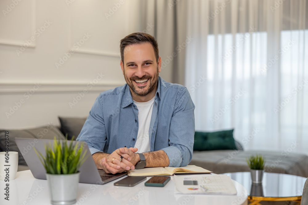 Young freelancer is smiling, working in nice modern home Young freelancer is smiling, working in nice modern home