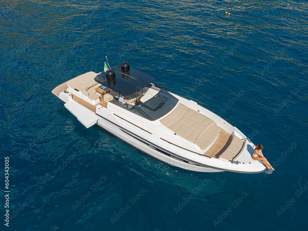 aerial view Young woman on a yacht in the amalfi coast, positano, italy